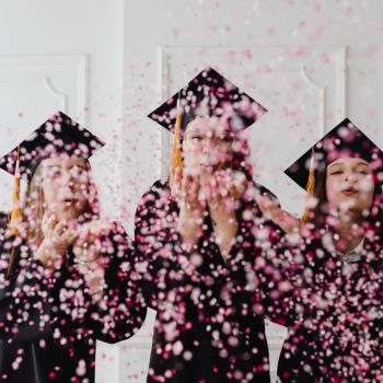 Girls graduating and blowing pink sprinkles to the camera