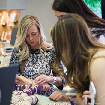 Andrea showing some bracelets to two girls
